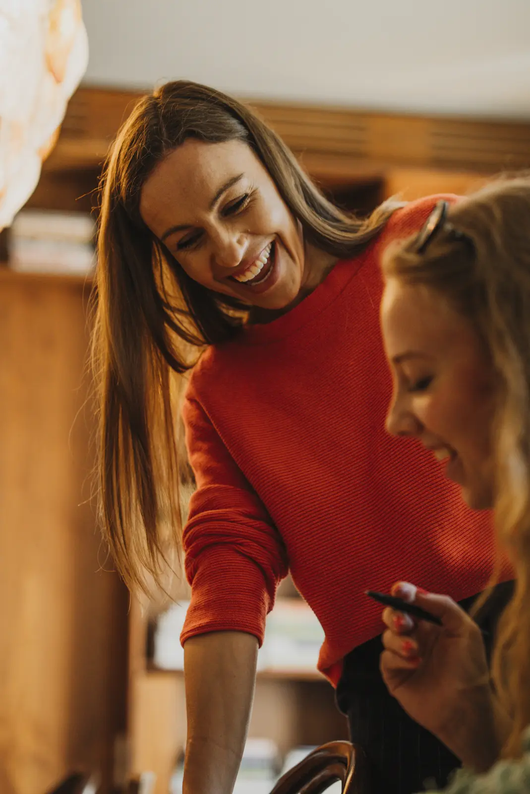 Lena laughing with a student while working through an exercise
